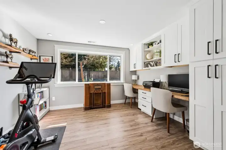 The sliding barn door allows you to close it off for privacy, which makes it a great option for a home office, study zone, or even a quiet retreat. The large window overlooking the backyard fills the room with light, and the wood-wrapped trim adds a subtle upgrade that carries throughout the home. Built-in cabinetry and dual desk areas give you plenty of room to spread out, whether that’s for work, school, or hobbies. Recessed lighting keeps everything well lit without clutter, and the flexibility here is a big plus. It can easily function as a guest room, media space, or anything else you need behind a door.