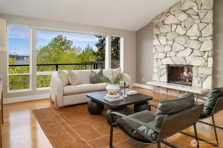 A stately stone fireplace anchors this elegant living space.
