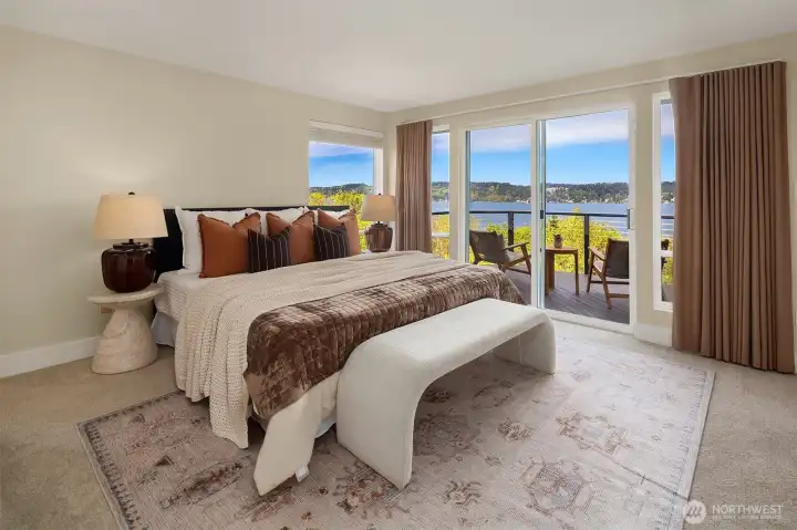 Main floor primary suite with access to the upper deck.