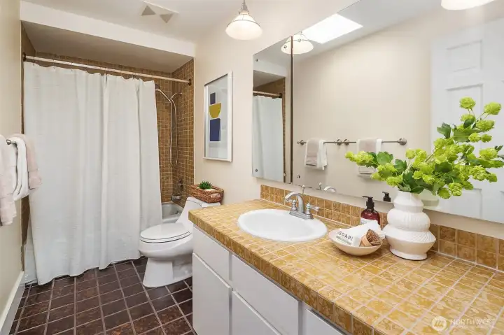 Full bath shared by 2 bedrooms on the main floor with skylights