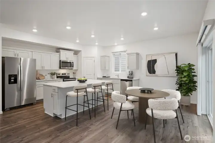 Large kitchen with informal dining area that doubles as open office space or breakfast nook. Photo is representational. Actual home is under construction. Colors, materials, and features may vary. See site agent for details.