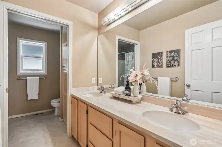Shared large hallway bathroom with dual sinks. Shared large hallway bathroom with dual sinks.