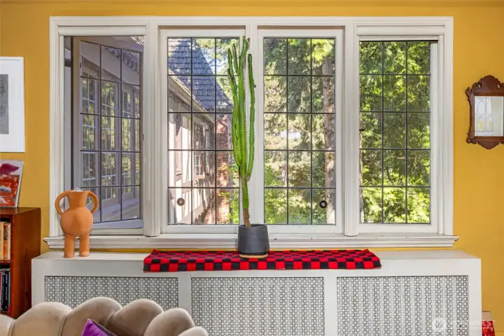 Oversized leaded glass windows floods the living room with natural light in the mornings.