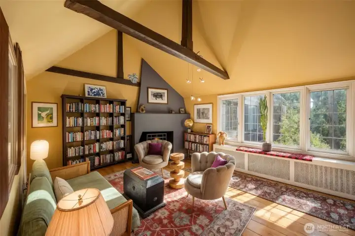 Inviting living space centered around a wood-burning fireplace, blending timeless character with warm and comfortable gathering spaces.