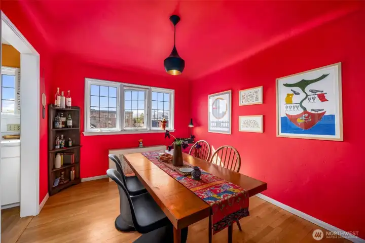 Dining room wrapped in bold color and natural light, creating the perfect setting for entertaining or cozy dinners at home.