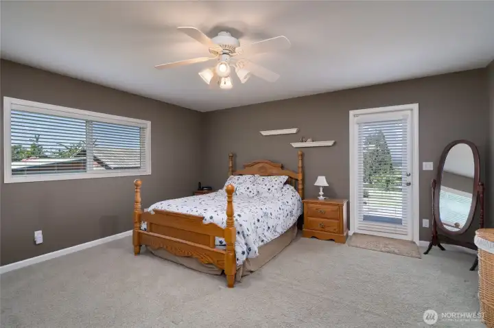 Spacious primary bedroom with access to deck. Bedroom has double closets. Spacious primary bedroom with access to deck. Bedroom has double closets.