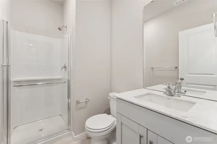 Main floor 3/4 bathroom featuring a walk-in shower. Photos are representative only and may display different color packages and/or upgrades.
