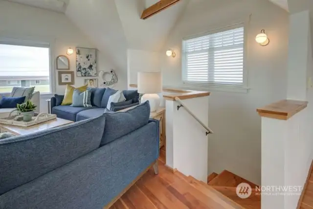 Once up the stairs off the main entry is the large gathering space with a ton of natural light and vaulted ceilings!