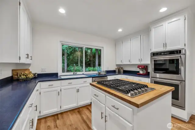 Cooks dream kitchen with center cooking island has plenty of counter and storage space