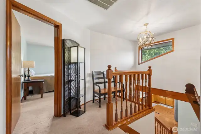 Upstairs loft-style landing offers an open connection to the bedrooms—bright, airy, & functional for flexible living.