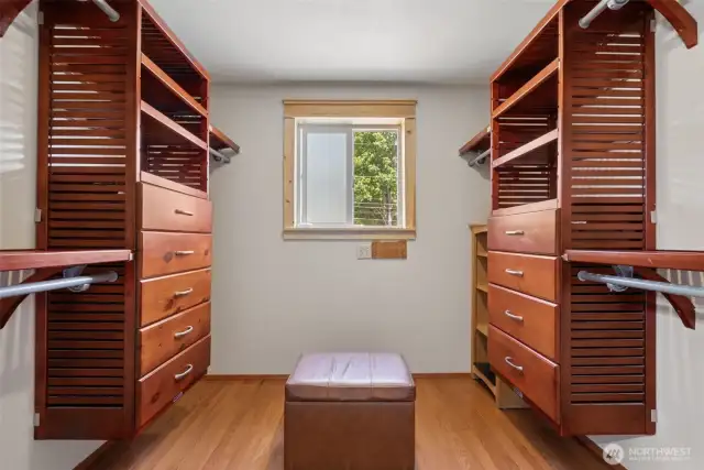 Primary walk-in closet outfitted w/ a high-end built-in organization system—designed for style, space & daily ease.