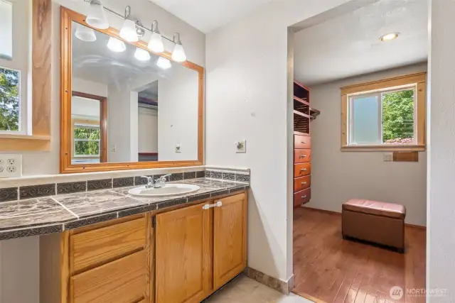 Primary en suite bath connects seamlessly to the walk-in closet—designed for convenience & daily flow.