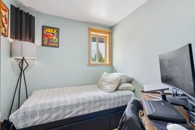 Cozy bedroom offers a quiet retreat w/ a more subdued, calming ambiance—perfect for rest or focused space.