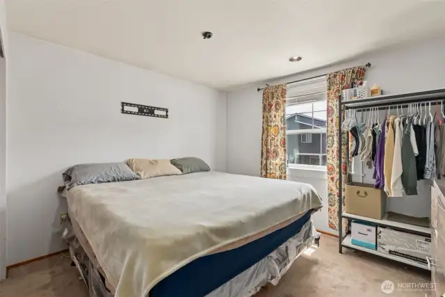 Well-sized bedroom featuring a nice window that brings in soft natural light—versatile & inviting.