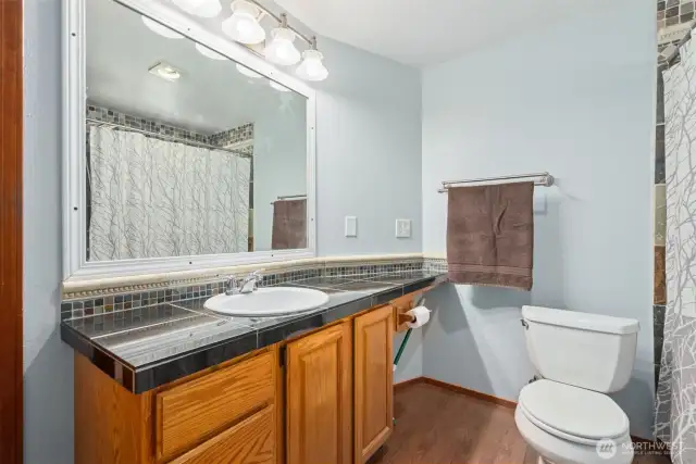Upstairs shared bathroom w/ extended counter space—ideal for busy mornings & practical daily use.