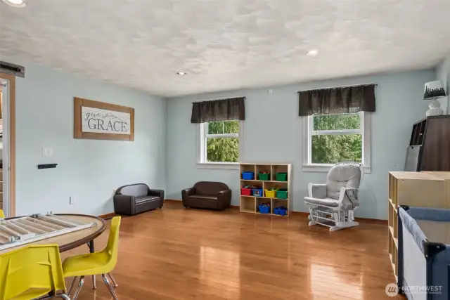 Another angle of the entry-level flex space—highlighting generous windows that fill the room w/ natural light & endless possibilities.