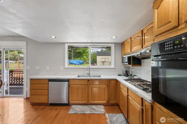 Bright kitchen featuring a built-in wall oven, open layout, & seamless flow for everyday living or hosting.