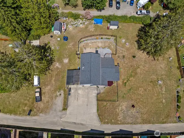 Aerial overview captures the entire property—showcasing lot size, home placement, outdoor areas & peaceful private-road setting.