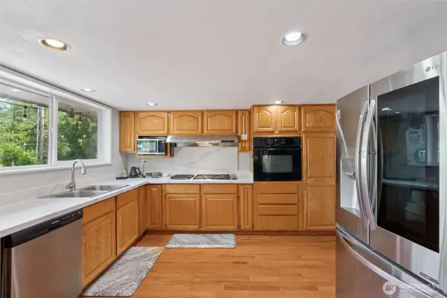Sleek kitchen view highlighting the high-end LG fridge w/ InstaView window—modern style meets everyday convenience.