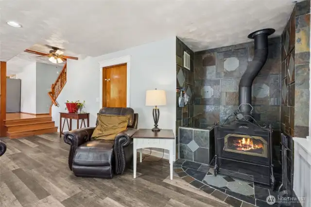 Classic wood-burning stove adds warmth, charm & a cozy focal point to the lower-level living space.