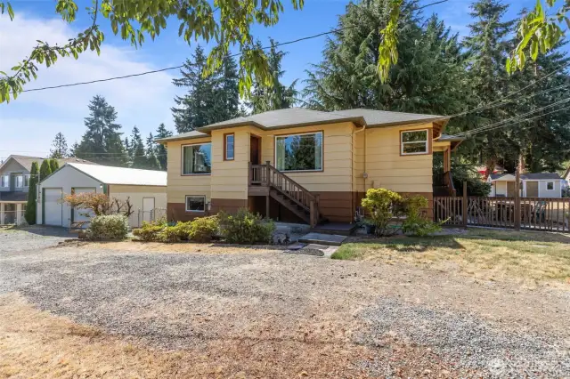 Front of house with view of shop, side yard, and garden shed.