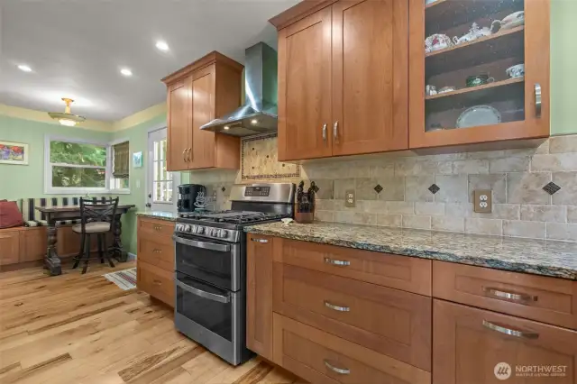 View of kitchen and dining nook. Back door leads to patio and side yard.