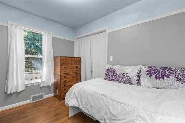 Second bedroom (main floor) with oak flooring.