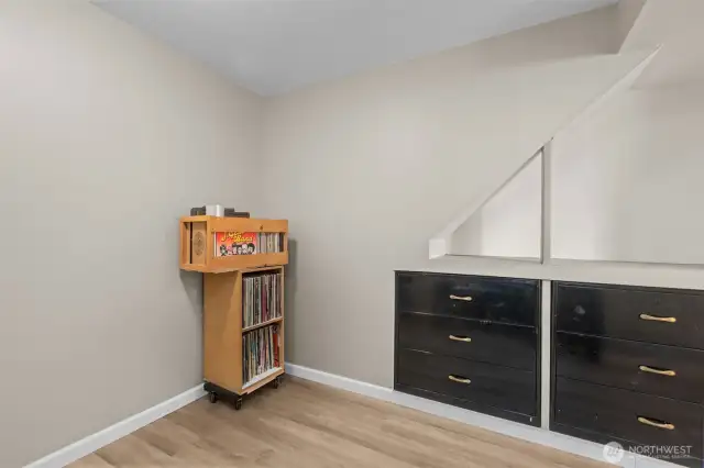 View of bedroom#2 on lower level with built-in drawers/storage.