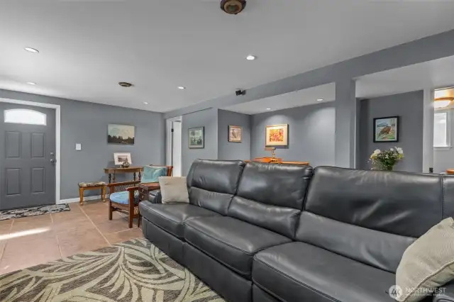 View of rec room on lower level. Basement door leads to shop and driveway.