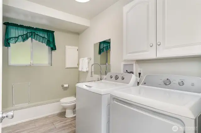 Bathroom also contains the washer and dryer with storage space.