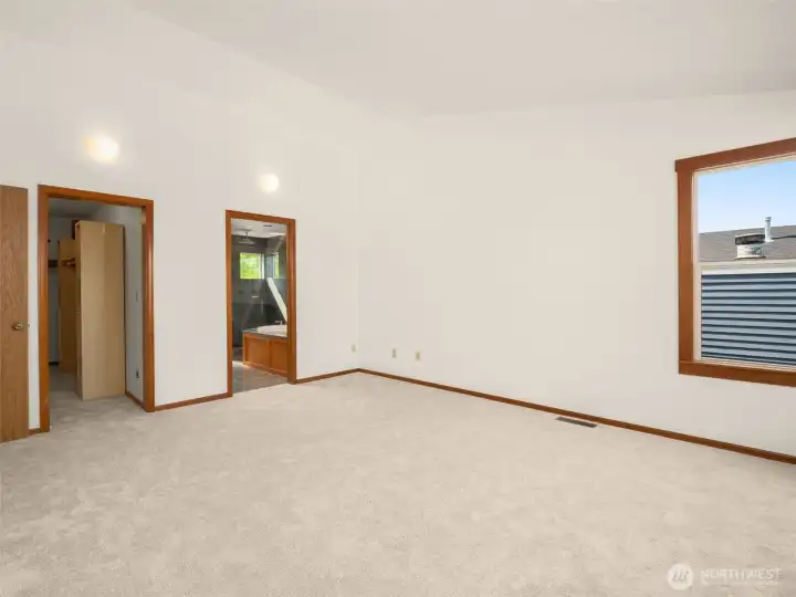 Primary bedroom looking into the spacious walk-in closet and primary bath