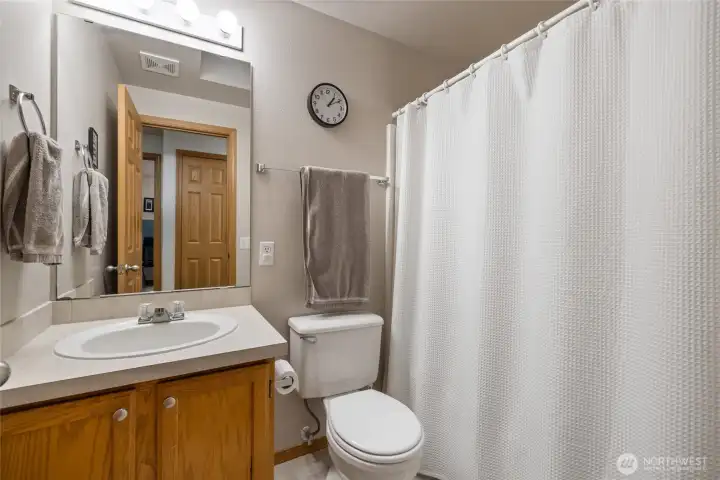 Main bathroom is tucked in the hallway, away from the main living spaces, creating a more private experience.