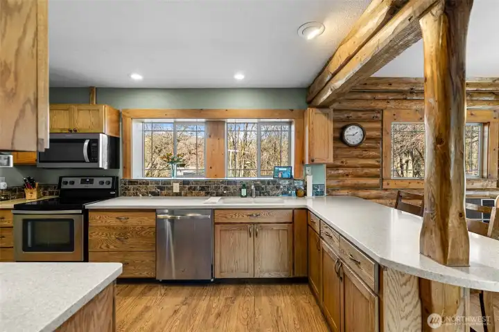 Kitchen with Window Views -  Large windows over the sink frame peaceful foothill views, bringing natural light into the heart of the home while you cook, gather, and enjoy Chelan living.