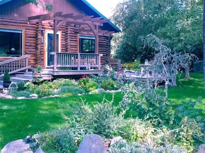 Please note: The current photos were taken in winter. During spring and summer the yard comes alive with lush grass and abundant perennials, creating a beautiful garden setting.