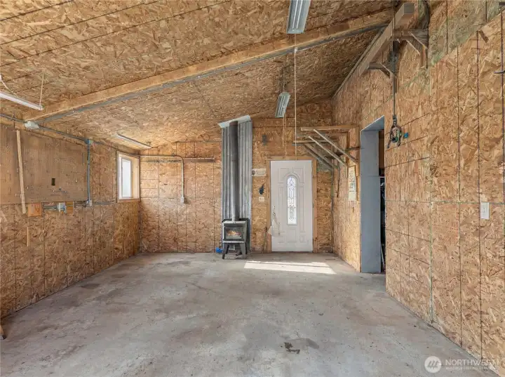 Shop with Wood Stove   Well-equipped shop features a wood stove for year-round comfort, ample storage options, and flexible layout to suit a variety of needs.