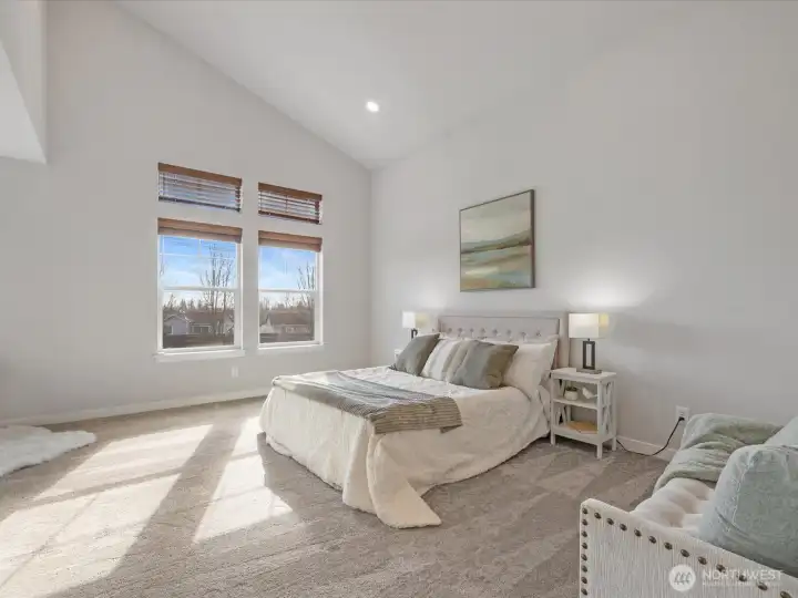 Expansive primary suite with vaulted ceilings.