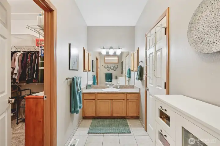 Remodeled primary bathroom with updated finishes, walk-in closet, and heated floors.