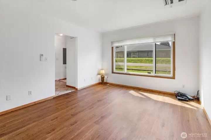 Bright living room, with ceiling flush mounted mini-split for heat and A/C.