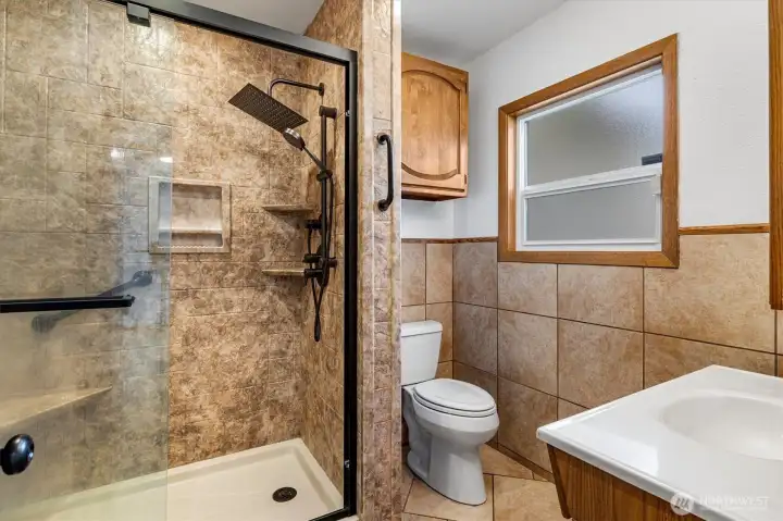 Tiled bath with lovely shower.
