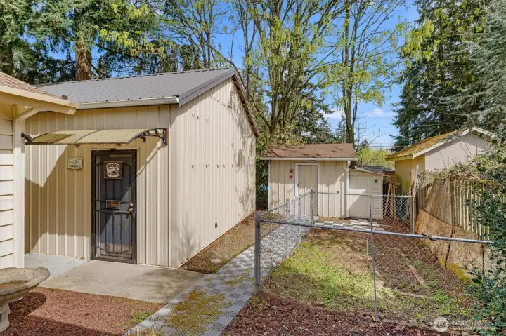 Man door to the garage/shop, plus an extra storage shed.
