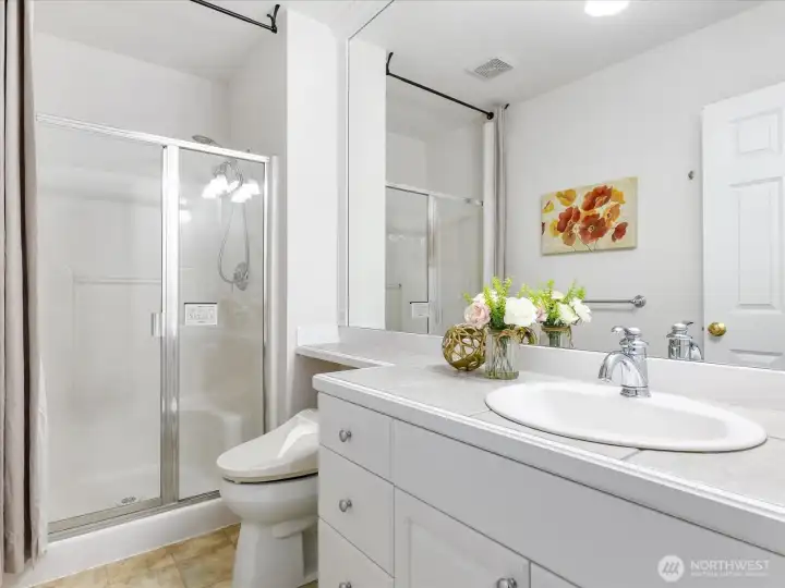 Bathroom with a shower conveniently located next to the bedroom.