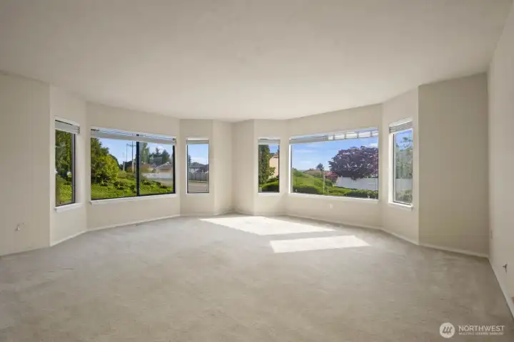 Bright living area with large windows and flexible open space for a variety of layouts