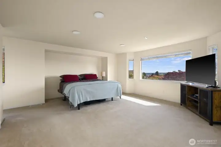 Generous primary bedroom with large windows, natural light, and flexible layout options.