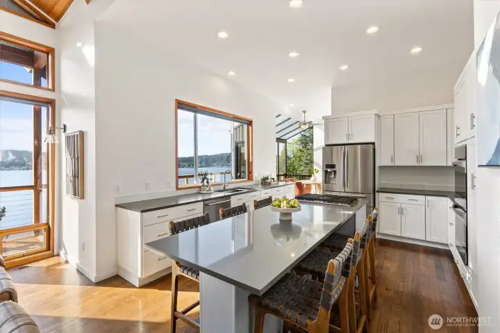 Sleek finishes and thoughtful storage make this kitchen functional. There is plenty of seating at the bar!