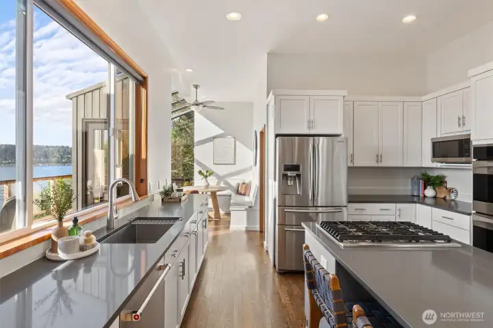 All the things we can appreciate in a lux kitchen: stainless, Quartz, large stainless sink, gas cooking, walls of cabinets. The laundry/mud room is right around the corner.