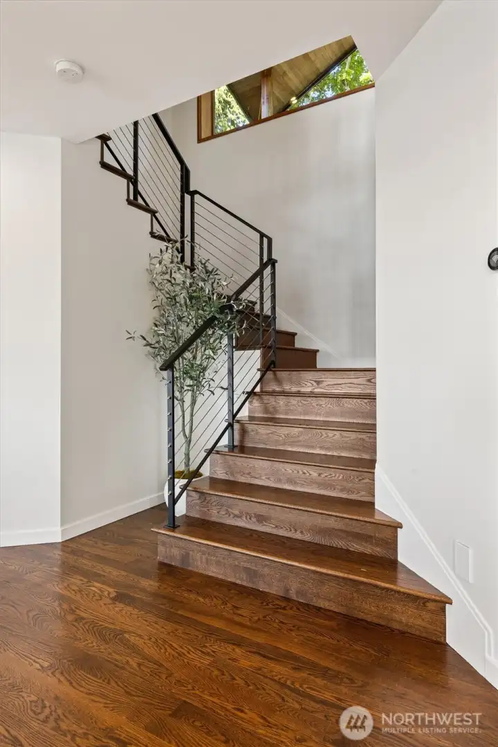 The stunning staircase maneuvers from the upper to lower floors.