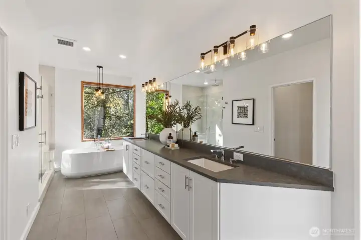 Spa-inspired luxury at every turn. The dual vanity extends towards the soaking tub.