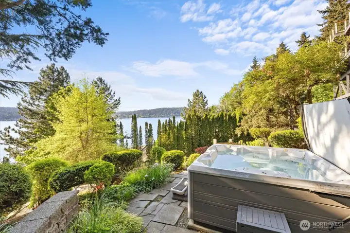Unwind in the hot tub while soaking in peaceful water views. The hot tub is just steps from the primary.
