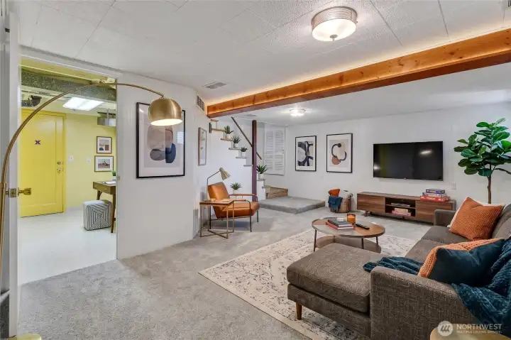 Virtually staged Lower level Rec-room with entry to laundry room.