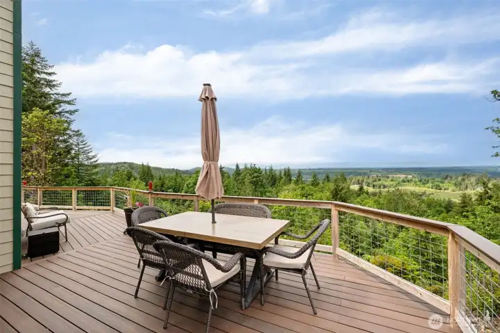 This deck is an absolute showpiece! Spanning nearly 1,000 square feet, the massive solid wood deck stretches across the home soaking in breathtaking northeast-facing views of the Olympic Mountain range along with stunning glimpses of Mount Rainier rising in the distance. There is room out here for everything, oversized dining setups, outdoor lounging, gatherings, quiet mornings, late-night stargazing or simply sitting in complete silence while nature aggressively heals your nervous system. The deck and railings were also recently reinforced adding even more confidence and longevity to this already incredible outdoor living space. And because the home sits atop more than 20 acres of private land, the scenery and peacefulness here feel remarkably protected and secluded, creating that rare sense of true retreat while still remaining connected to modern conveniences below the mountain.